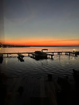 a boat on a dock in the water at sunset at woonboot de dobber loosdrechtse plassen 4-8 personen in Loosdrecht