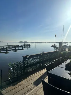 a view of a marina with a table and chairs at woonboot de dobber loosdrechtse plassen 4-8 personen in Loosdrecht