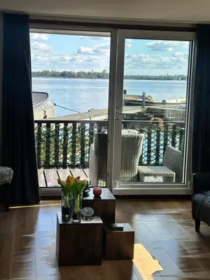 a living room with a large view of the water at Woonboot De Witte loosdrechtse plassen in Loosdrecht
