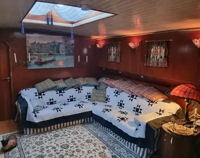 a bedroom with two beds on a boat at art deco houseboat on super location in Amsterdam