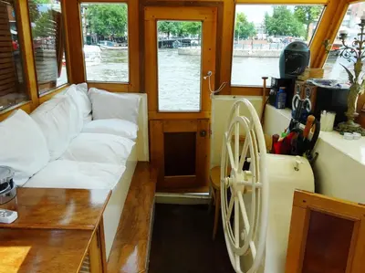 a living room with a white couch in a boat at art deco houseboat on super location in Amsterdam