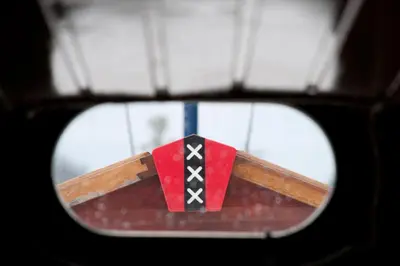 a rear view mirror of a skateboard with a flag at art deco houseboat on super location in Amsterdam