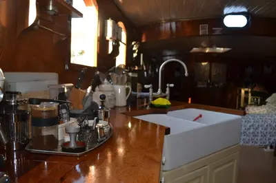 a kitchen with a counter top with a sink at art deco houseboat on super location in Amsterdam