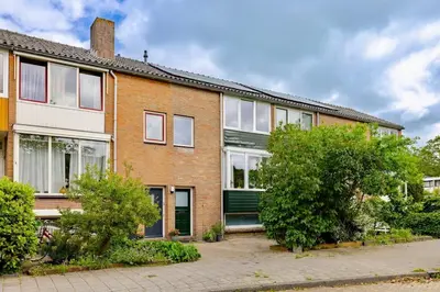 a brick house with trees in front of it at Family home in Haarlem with garden, near beach & Amsterdam in Haarlem