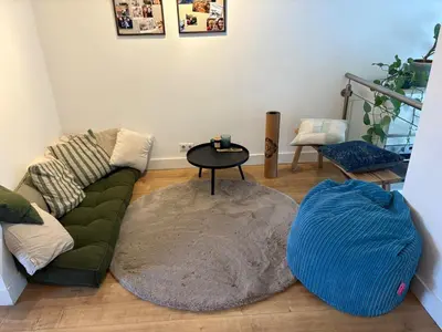 a living room with a couch and a table at Family home in Haarlem with garden, near beach & Amsterdam in Haarlem