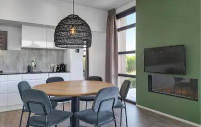 a kitchen and dining room with a table and chairs at Gorgeous Home In Nijkerk With Wifi in Nijkerk