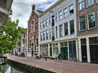 a row of buildings on a street next to a canal at Gouda city center apartment with private garden and 2 bicycles in Gouda