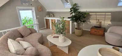a living room with a couch and a table at Studio 21 stylish and luxurious apartment in Noordwijk