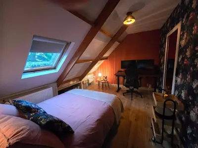 a bedroom with a bed and a desk with a piano at Ossestal in Assendelft