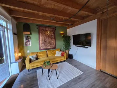 a living room with a couch and a table at Ossestal in Assendelft