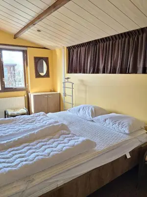 a large bed in a bedroom with a window at Rekerlanden 218 by ZILT in Warmenhuizen