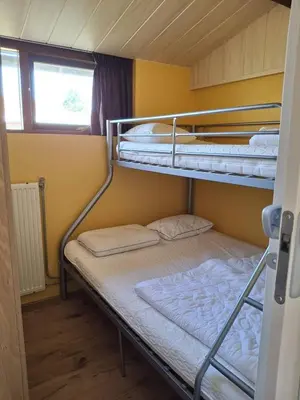 two bunk beds in a room with a window at Rekerlanden 218 by ZILT in Warmenhuizen