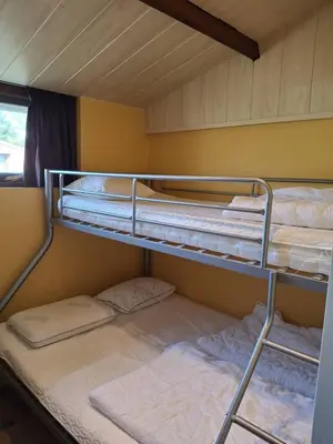 a bunk bed with two bunk beds in a room at Rekerlanden 218 by ZILT in Warmenhuizen