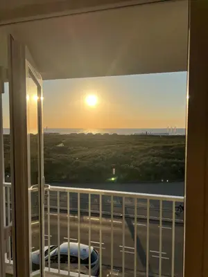 a view of the sunset from a balcony at Blvd 79 in Katwijk aan Zee