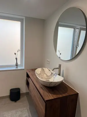 a bathroom with a sink and a mirror at Blvd 79 in Katwijk aan Zee