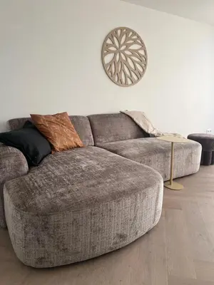 a grey couch in a living room with a white wall at Blvd 79 in Katwijk aan Zee