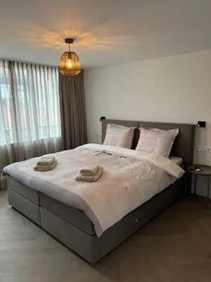 a bedroom with a large bed with towels on it at Blvd 79 in Katwijk aan Zee