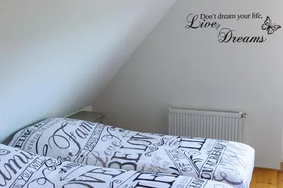 a bedroom with a bed and a wall at Buitenplaats Langewijk in Zuidoostbeemster