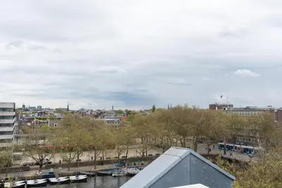 a view of a city with boats in the water at Central HotSpot Apartment in Amsterdam