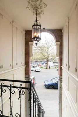 a hallway of a house with a chandelier at Central HotSpot Apartment in Amsterdam