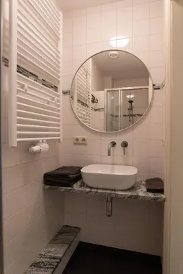 a bathroom with a sink and a mirror at Central HotSpot Apartment in Amsterdam