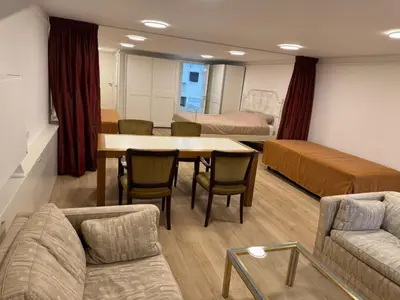 a living room with a table and chairs and a couch at Herengracht 204 Souterrain Studio Apt without kitchen in Amsterdam