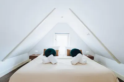 a bedroom with a large bed with two pillows at Staal House in Amsterdam