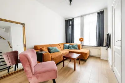 a living room with a couch and a chair at The Alkmaar Family House in Alkmaar