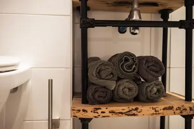 a pile of towels on a shelf in a kitchen at Another day in paradise in Tuitjenhorn
