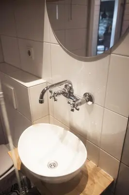 a bathroom with a white sink and a mirror at Another day in paradise in Tuitjenhorn