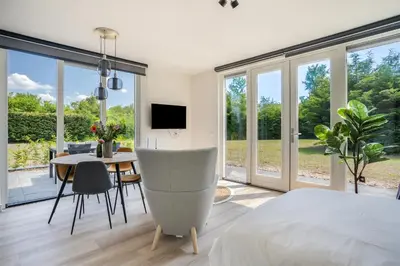 a bedroom with a bed and a dining room with a table at Mereveld Studios in Utrecht