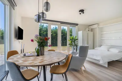 a room with a table and chairs and a bed at Mereveld Studios in Utrecht