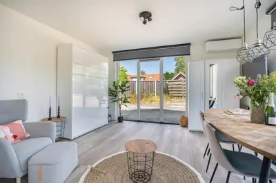 a dining room and living room with a table and chairs at Mereveld Studios in Utrecht