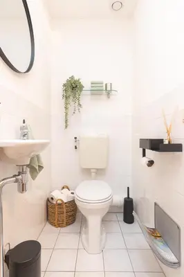 a white bathroom with a toilet and a sink at Zaan City Deck in Zaandam