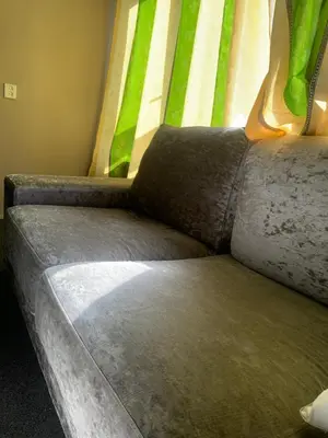 a couch sitting next to a window in a room at Connected comfort in Amsterdam
