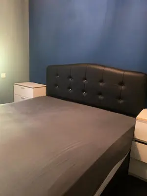 a bed in a room with a blue wall at Connected comfort in Amsterdam