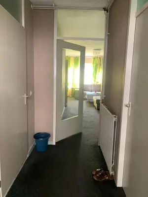 a hallway with a blue bucket in a room at Connected comfort in Amsterdam