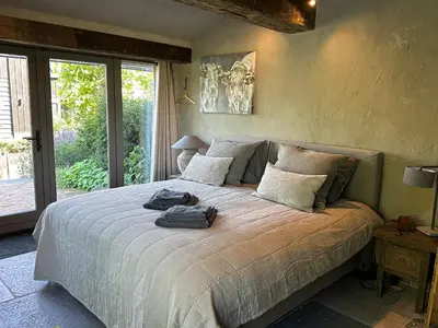 a bedroom with a large bed with towels on it at B&B De Wilgenhoeve in Kwadijk