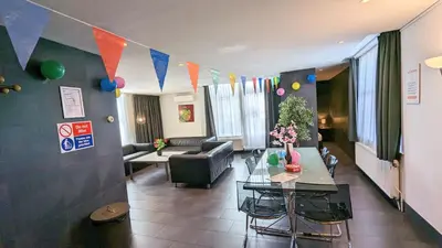 a living room with a couch and a table at The Amsterdam Hotel Apartment in the Center in Amsterdam