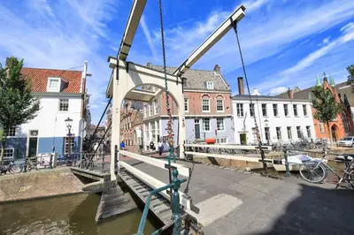 a crane lifting a bridge over a canal at The Amsterdam Hotel Apartment in the Center in Amsterdam