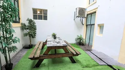 a wooden table sitting on top of green grass at The Amsterdam Hotel Apartment in the Center in Amsterdam