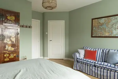 a living room with a bed and a couch at Zandhuys in Zandvoort