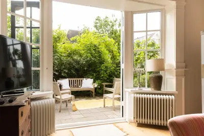 a living room with a large sliding glass door at Zandhuys in Zandvoort