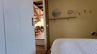 a bedroom with a bed and a view of a hallway at Vakantiehuis Lycka in Noordwijkerhout