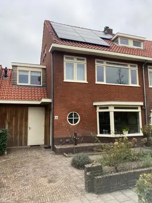 a brick house with solar panels on the roof at Appartement Buissant des Amorie! in Castricum
