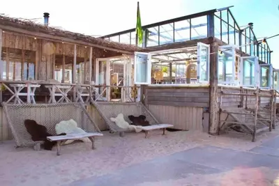 a building under construction with benches in front of it at Appartement Buissant des Amorie! in Castricum