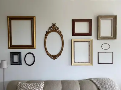 a group of mirrors on a wall with a couch at Appartement Buissant des Amorie! in Castricum