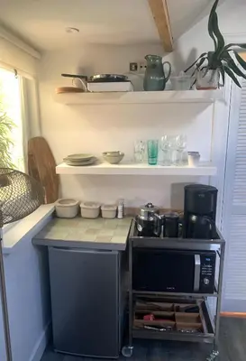 a kitchen with a microwave and a coffee maker at Little Betsy in Zandvoort
