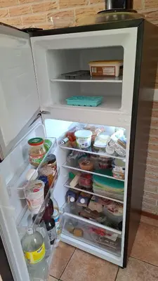an open refrigerator with its door open and food inside at Ankes Traumhaus in Sint Maarten