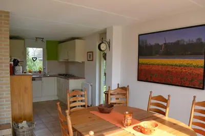 a kitchen and dining room with a table and a tv at Ankes Traumhaus in Sint Maarten